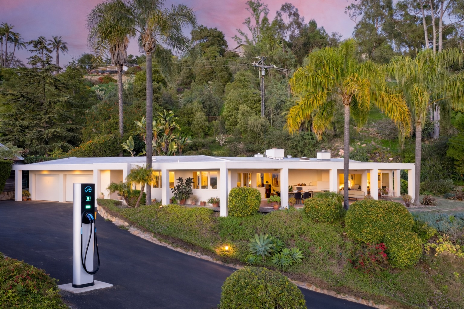 An EV charging station in the driveway of a luxury home.